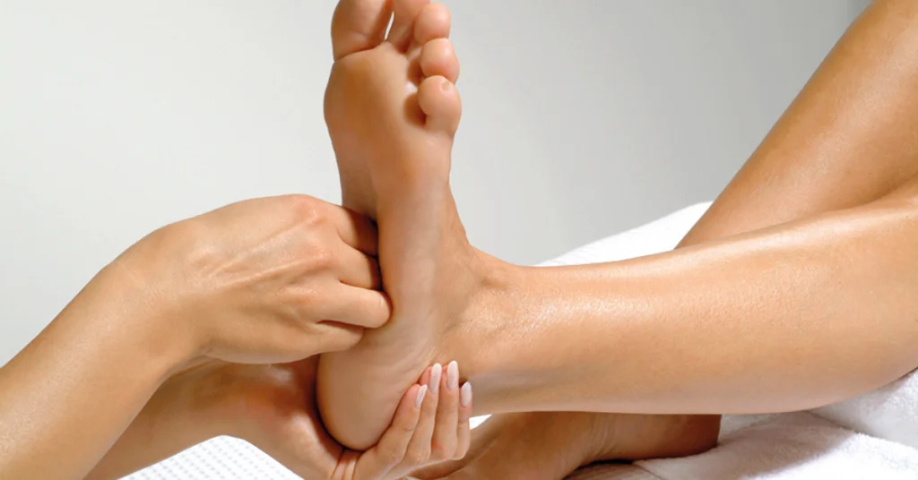Foot massage with lotus flowers alongside
